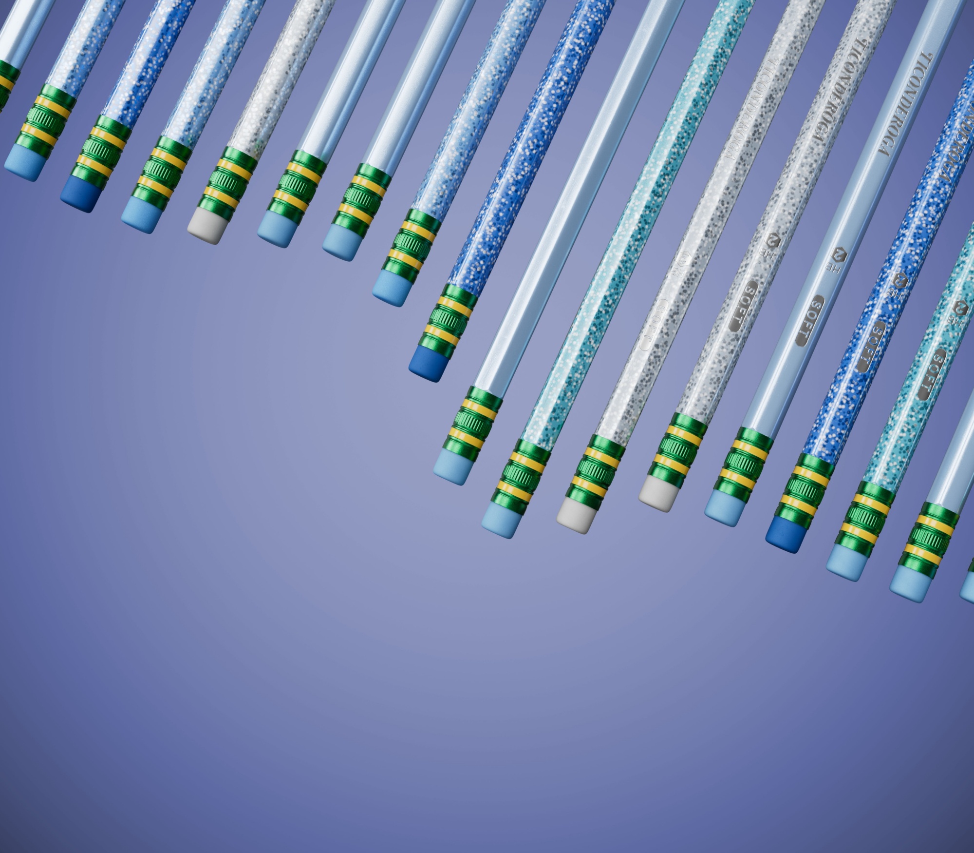 Colorful glitter pencils arranged in a creative layout against a purple background.