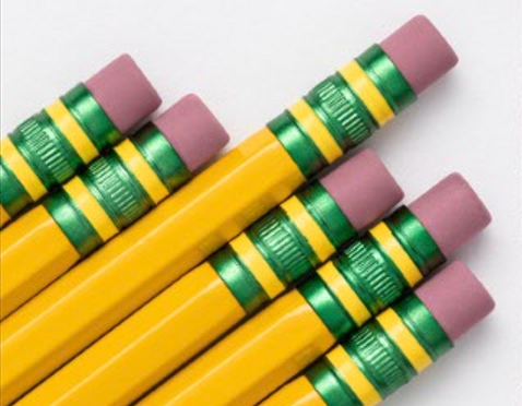 Group of yellow pencils with green and purple erasers arranged neatly.